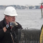 Burley Watkins, a Naval Surface Warfare Center Panama City Division (NSWC PCD) employee signals crane operator during on-load operations onboard research vessel (R/V) Lily Borledon Jan. 30, 2014. Watkins worked with Naval Surface Warfare Center Panama City Division (NSWC PCD) employees and Bay County Florida artificial reef planners to create an artificial reef in the Gulf of Mexico waters. Photo by Ron Newsome, NSWC PCD.