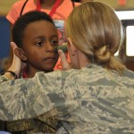 A Jr. Raptor gets face-paint to set him up for a mock deployment April 12 at Tyndall’s Hangar 5. More than 100 military children attended the Jr. Raptor event where military children went through a mock deployment. (U.S. Air Force photo by Airman 1st Class Solomon Cook)