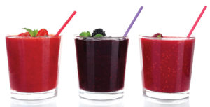 Raspberry, strawberry and blackberry cocktails isolated on white